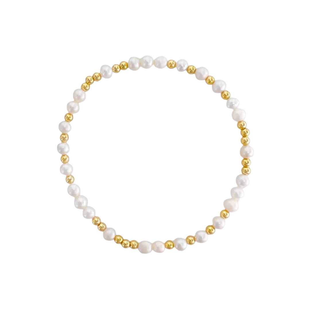 Pearl and gold bead stretch bracelet on a white background