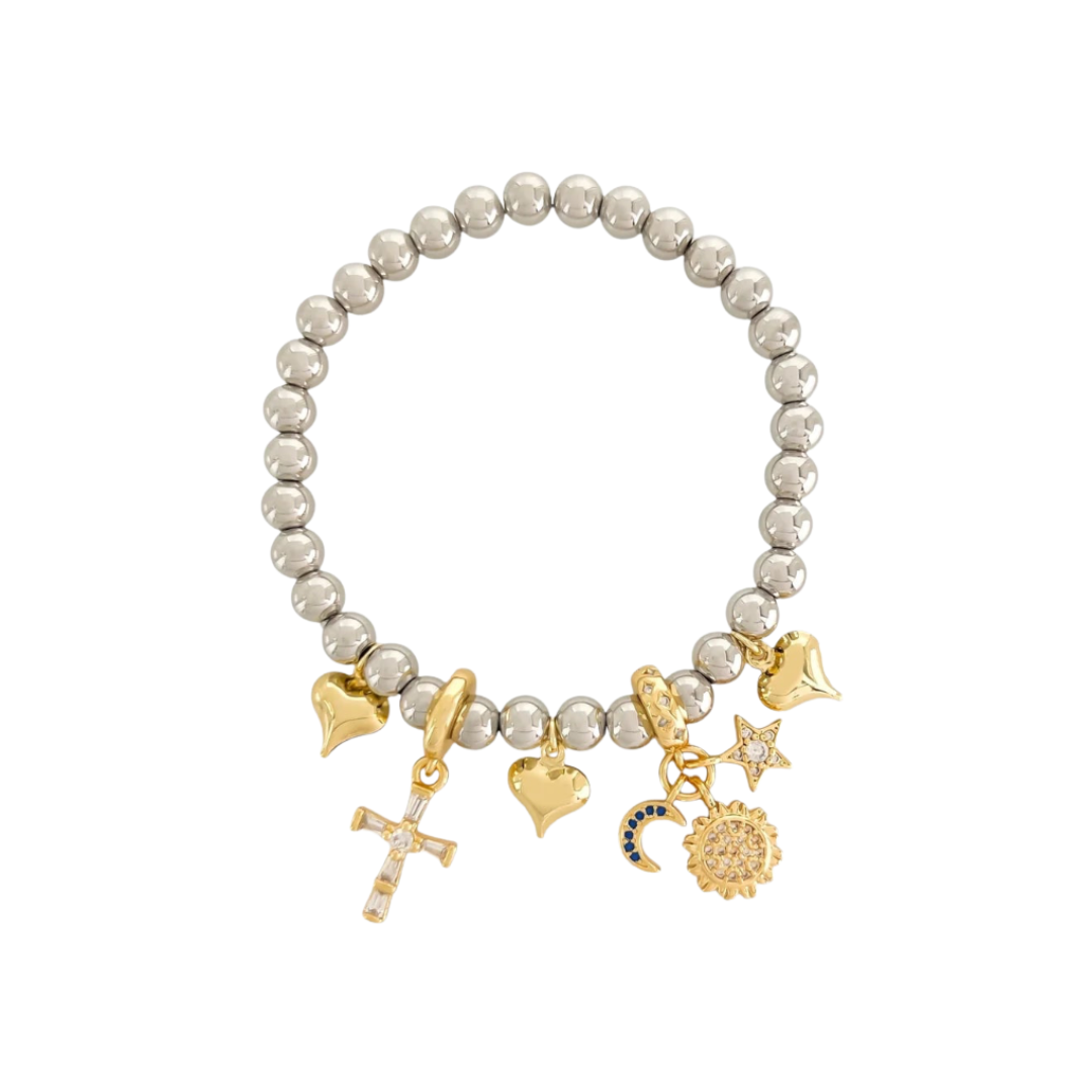 Beaded bracelet with gold charms and a cross charm on a white background