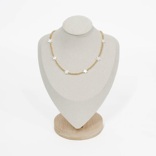 Beaded pearl icon star necklace on a white mannequin bust