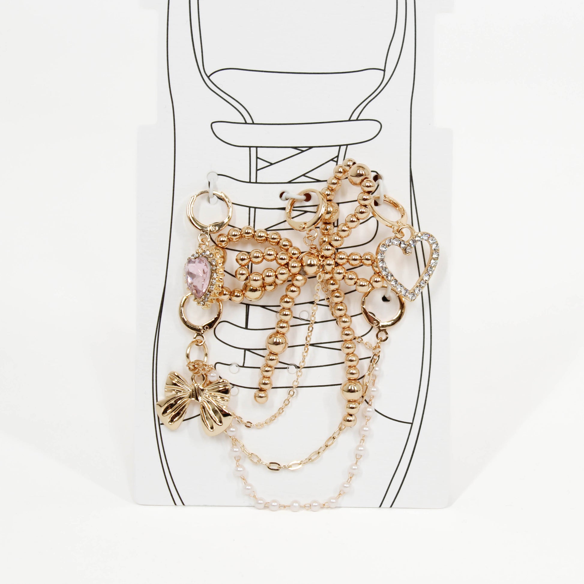Set of gold shoe charms on a shoe with a white background
