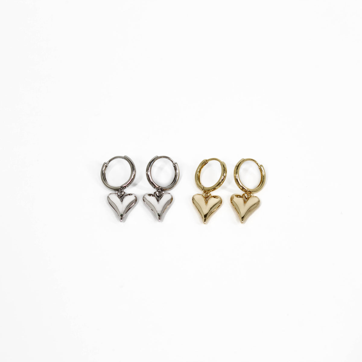Two pairs of heart-shaped bubble heart huggie earrings, one silver and one gold, on a white background.