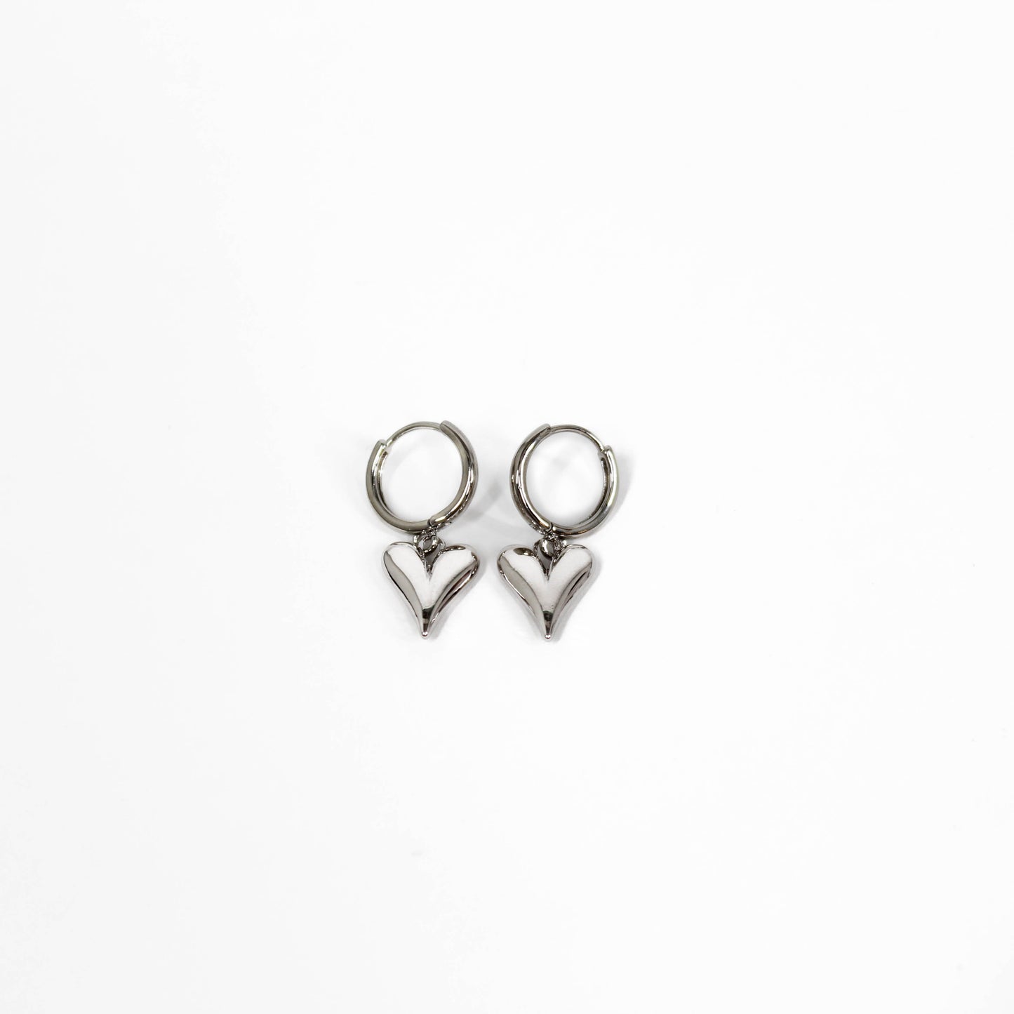 Pair of heart-shaped bubble heart huggie earrings on a white background