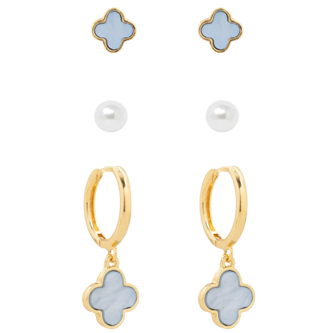 Gold earring set with blue clover-shaped charms on a white background