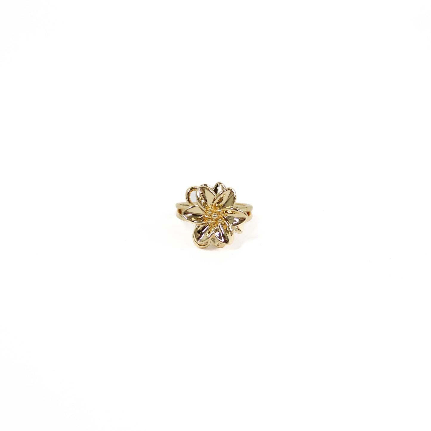 Gold flower-shaped statement ring on a white background