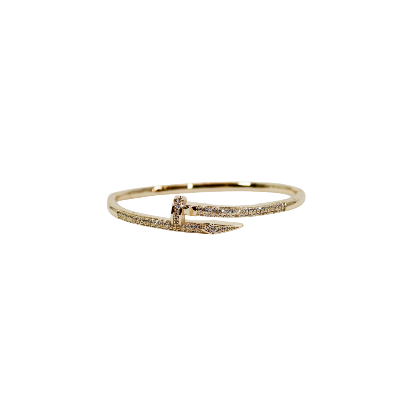 Gold nail bangle bracelet on a white background