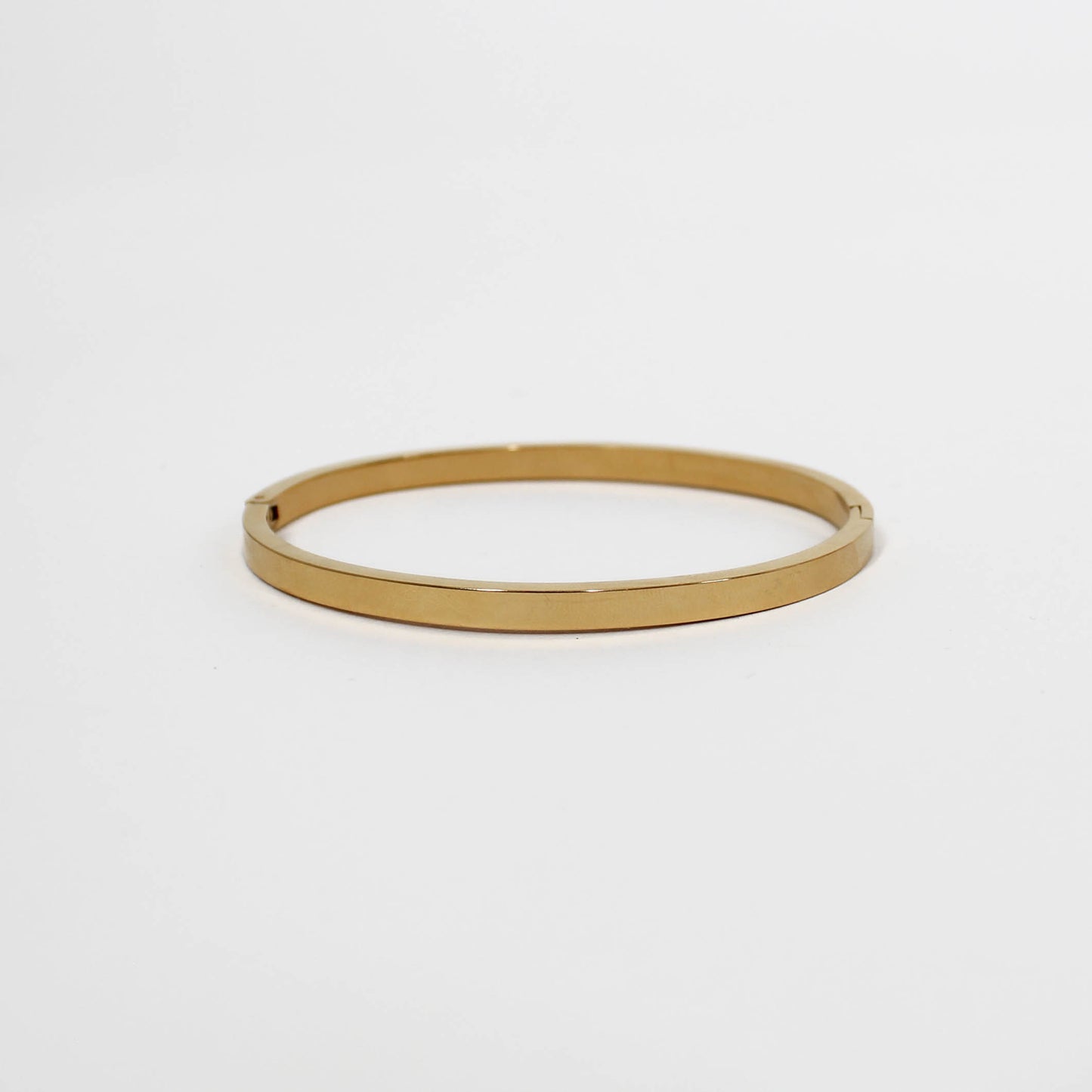 Gold bangle on a white background