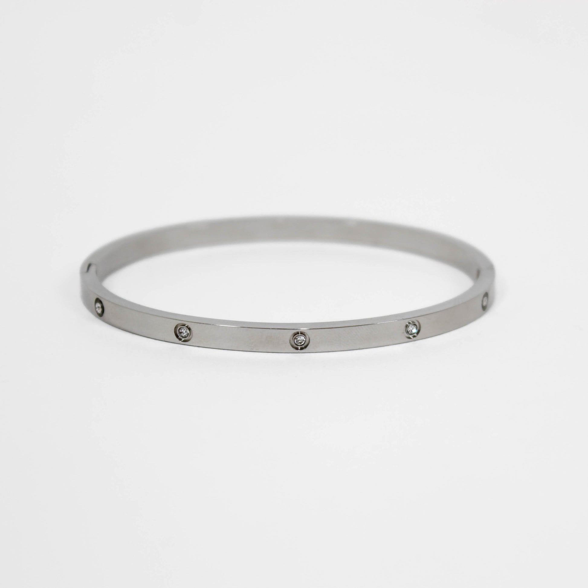 Silver bracelet with small stones on a white background