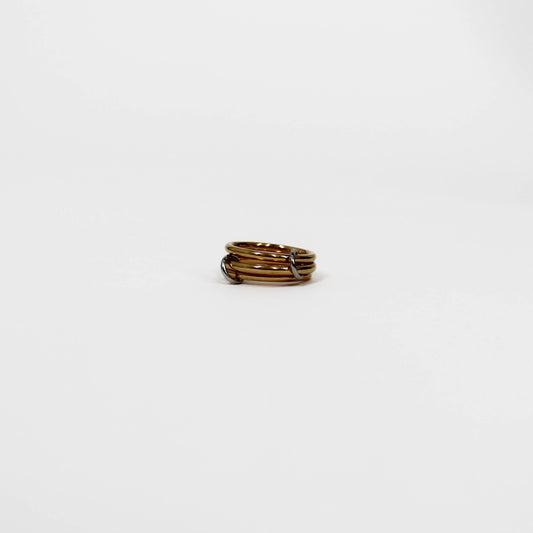 Gold interlocking link ring on a white background