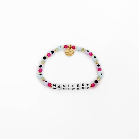 Little Words Project Bracelet with colorful beads and 'MANIFEST' charm on a white background