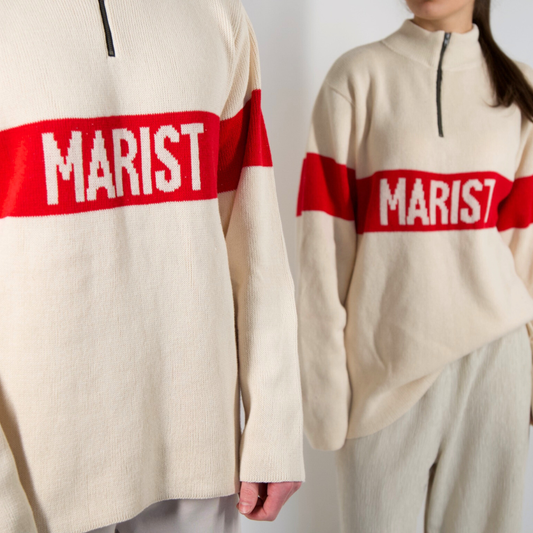 Two people wearing cream-colored sweaters with red bands displaying 'MARIST' on a plain background.