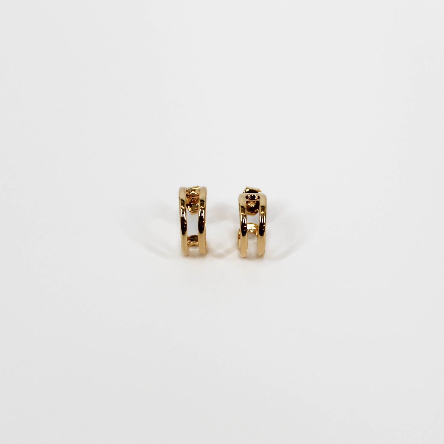 Gold open mini hoop earrings on a white background