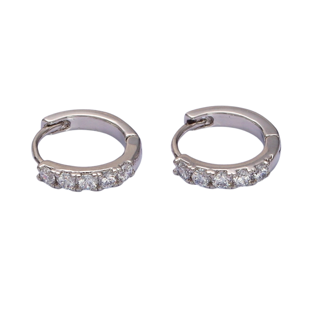 Pair of silver hoop pave huggie earrings with embedded stones on a white background