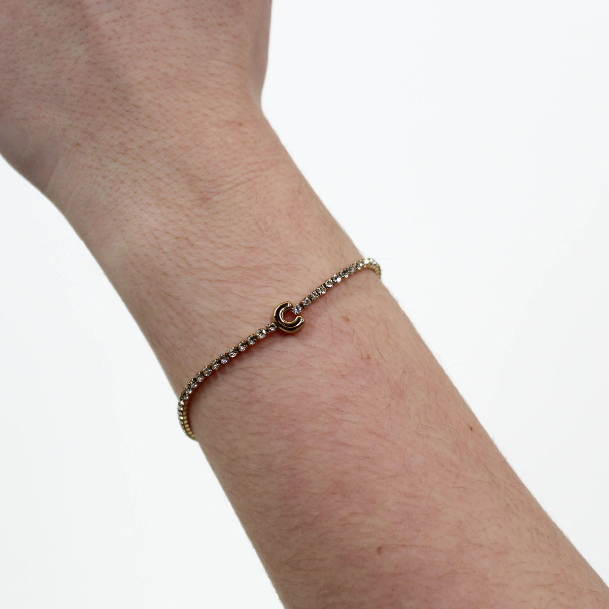 Rhinestone Letter Bracelet C on a wrist with a white background