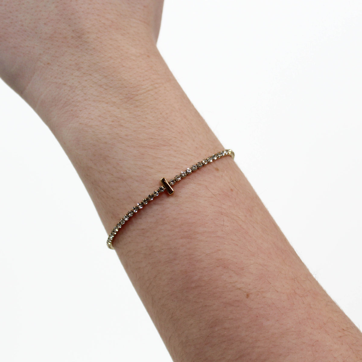 Rhinestone Letter Bracelet I on a wrist with a white background