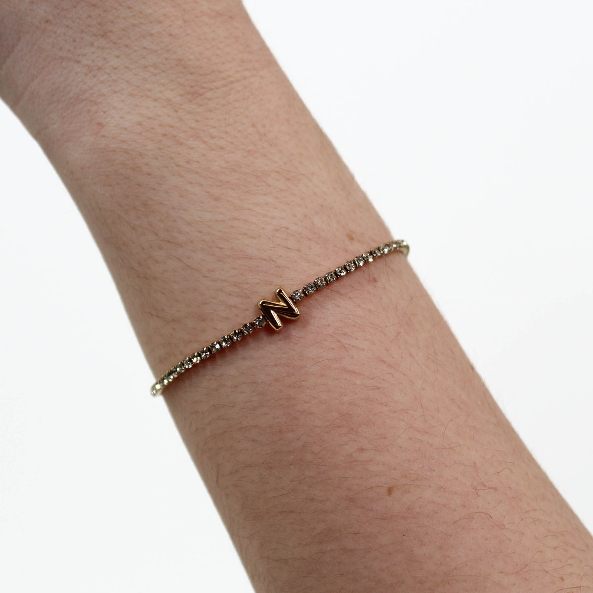 Rhinestone Letter Bracelet N on a wrist with a white background