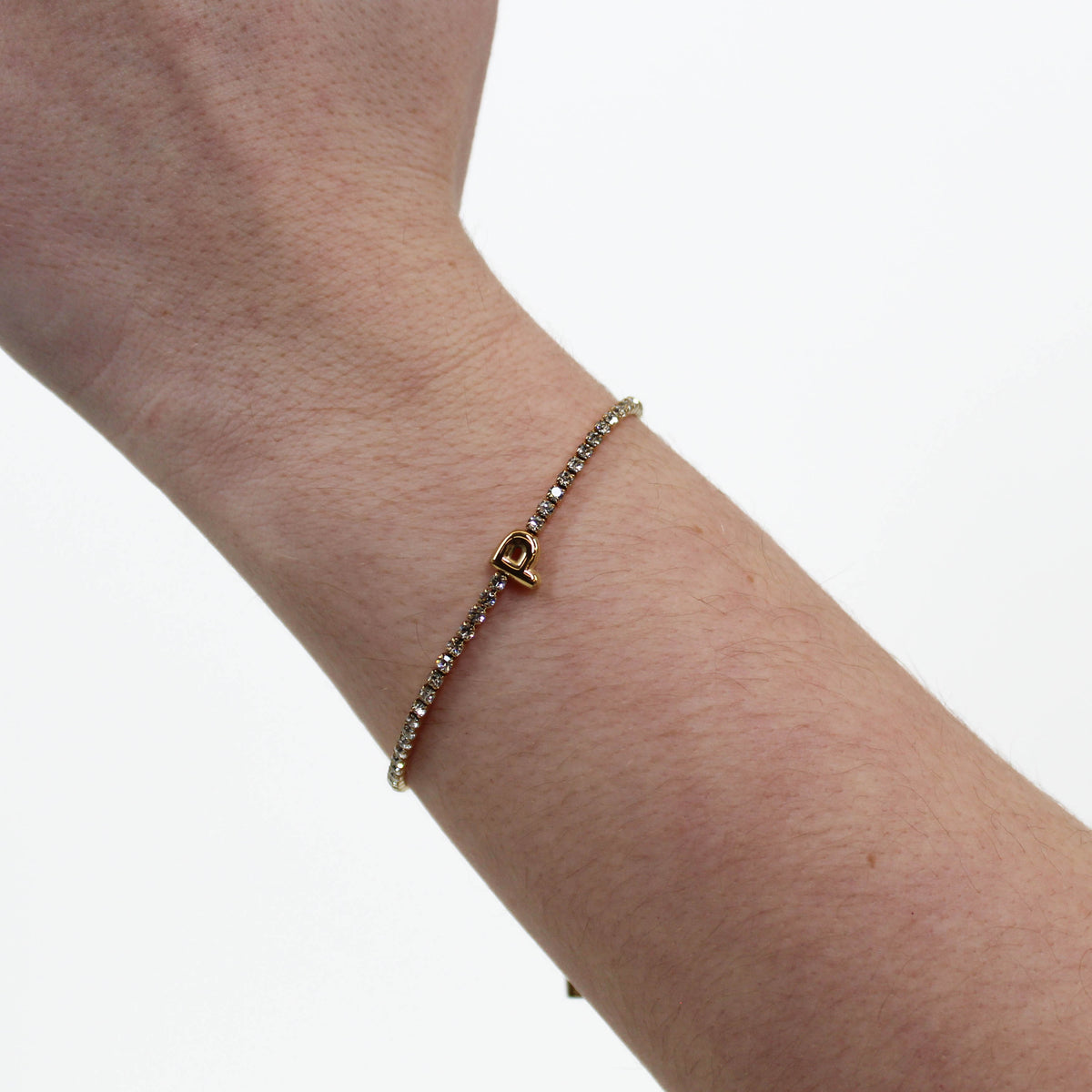 Rhinestone Letter Bracelet P on a wrist with a white background