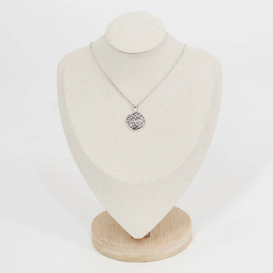 Necklace with a scripted M disc pendant necklace for Marist on a white mannequin bust