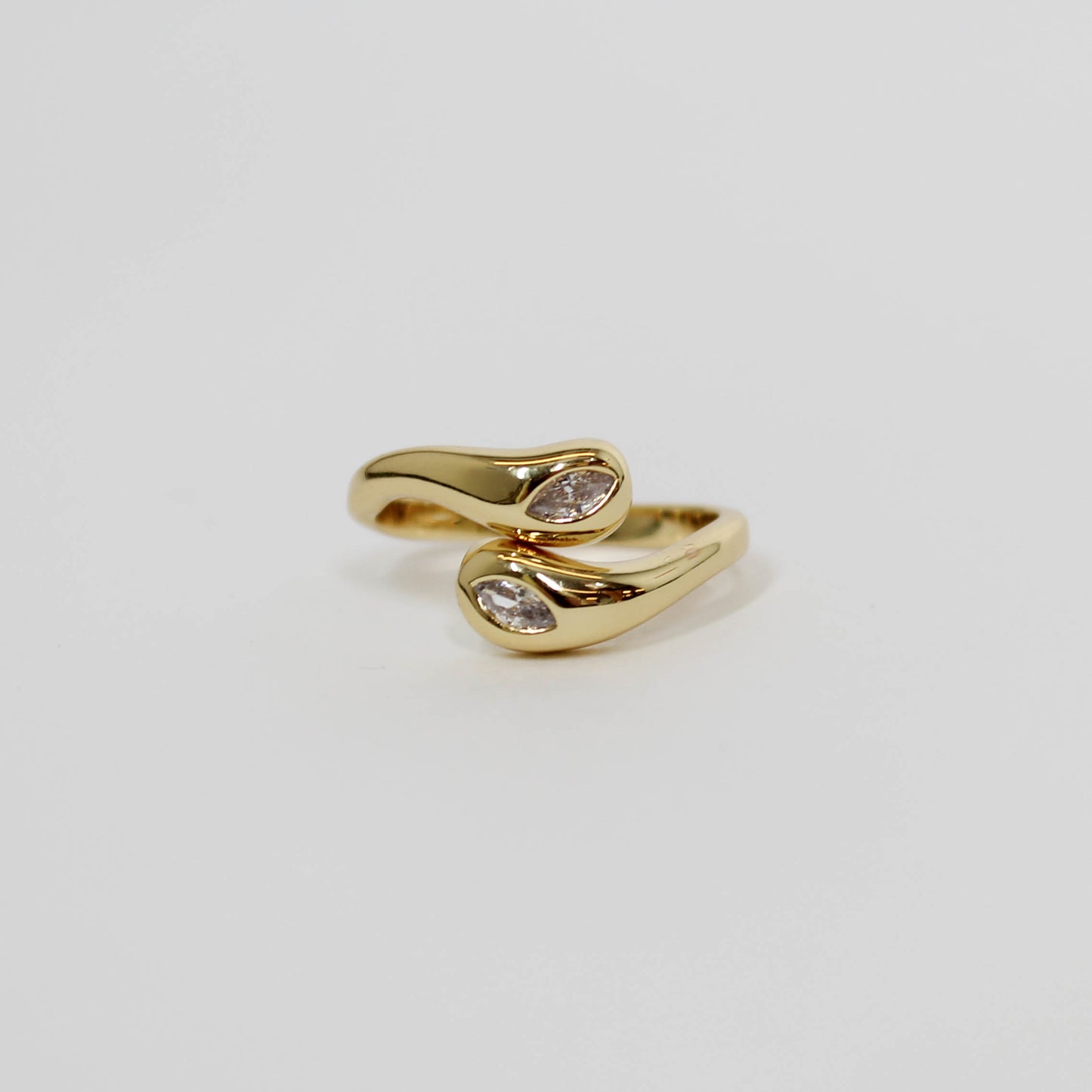 Gold wrapped ring with two embedded CZ stones on a white background