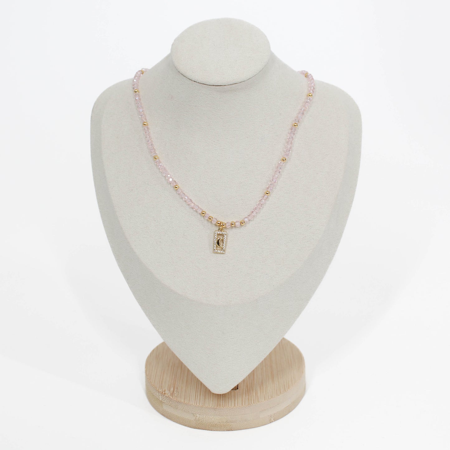 pink moon pave choker Necklace on a white mannequin bust with a plain background