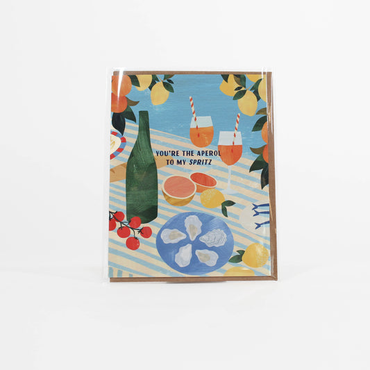 Greeting card with a summer scene featuring a bottle, glasses, and food on a striped background.
