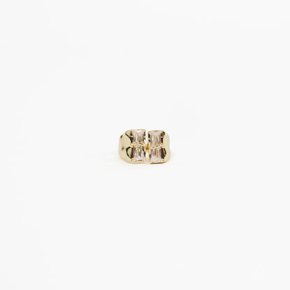 Gold baguette CZ signet ring with a clear gemstone on a white background
