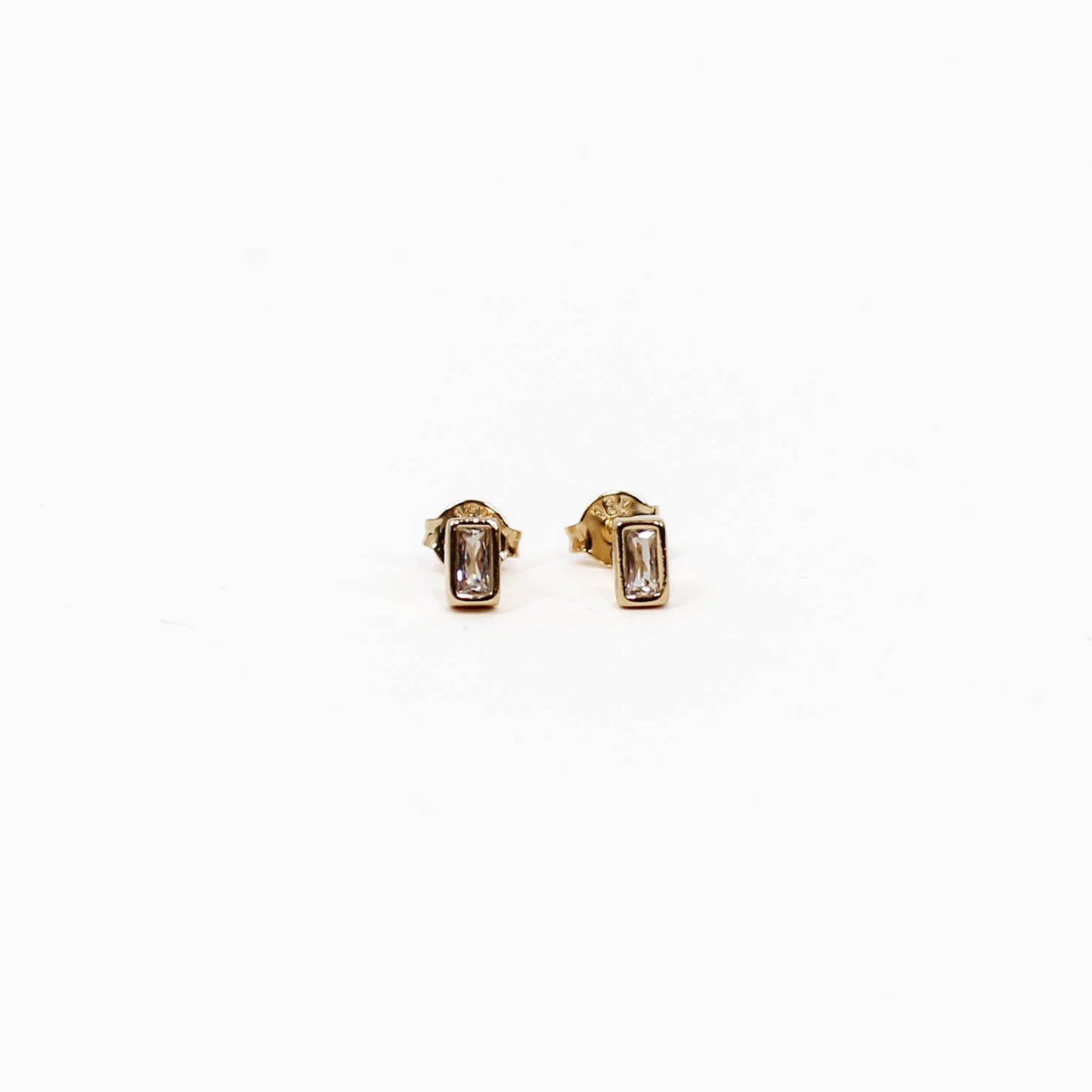 Gold baguette stud earrings with gemstones on a white background