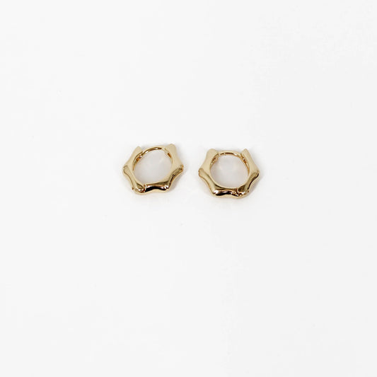Pair of gold bamboo hoop earrings on a white background