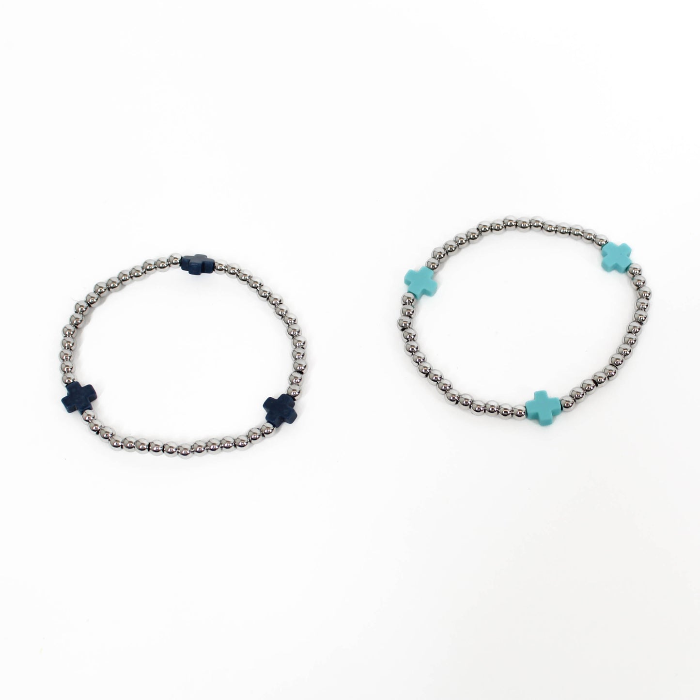 Two bracelets with silver beads and a blue and black cross accents on a white background.