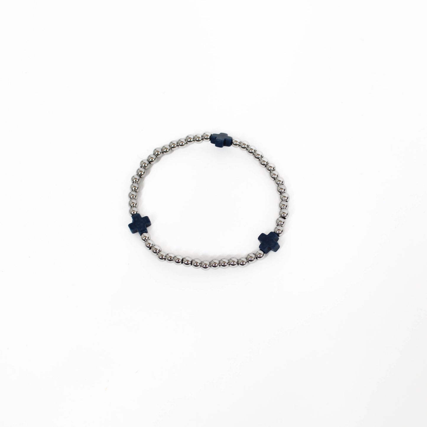 Bracelet with silver beads on a white background and black cross accents. 