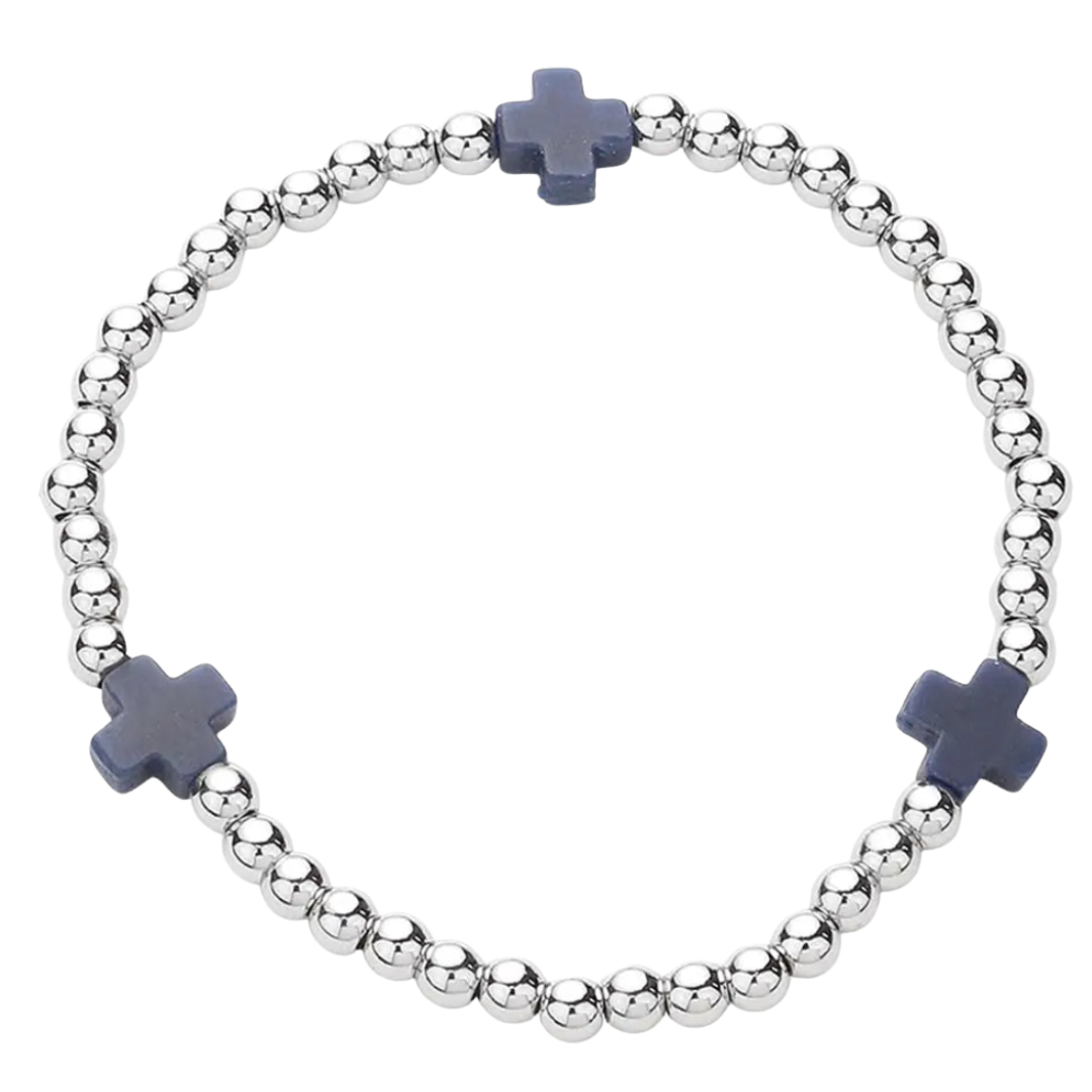 Bracelet with silver beads and black cross charms on a white background