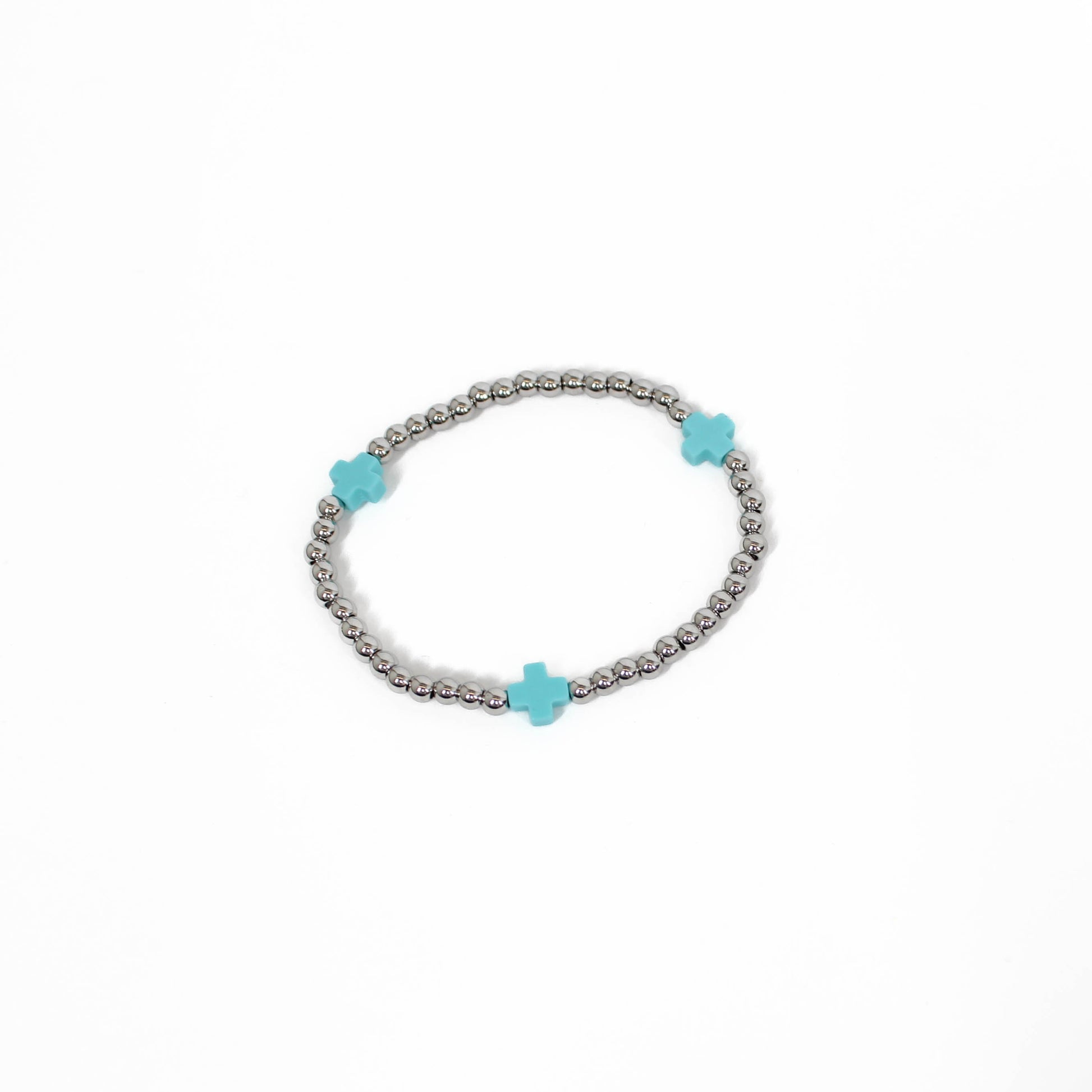 Bracelet with turquoise cross-shaped beads on a white background