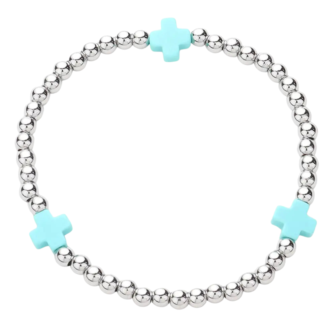 Bracelet with silver beads and turquoise crosses on a white background