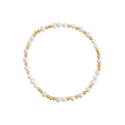 Pearl and gold bead stretch bracelet on a white background