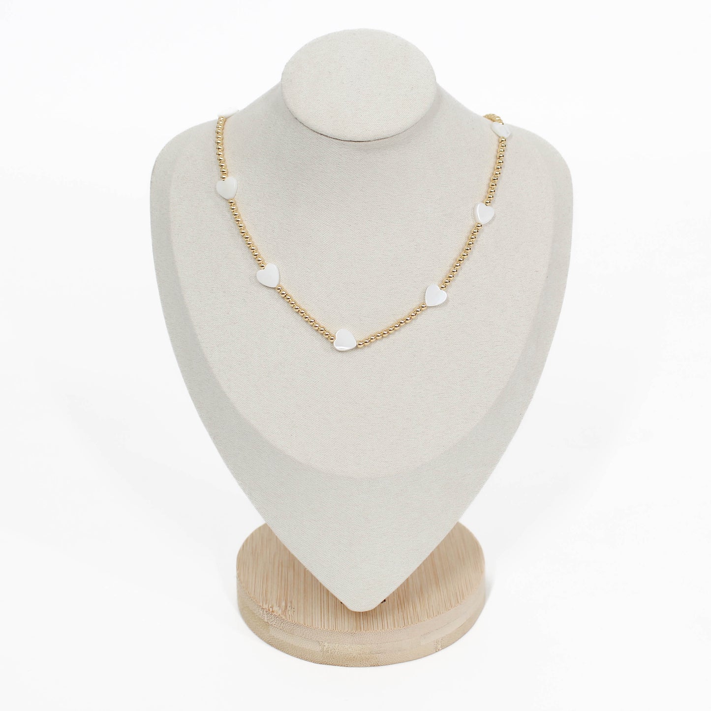 beaded pearl icon Necklace with heart-shaped pendants on a white mannequin bust