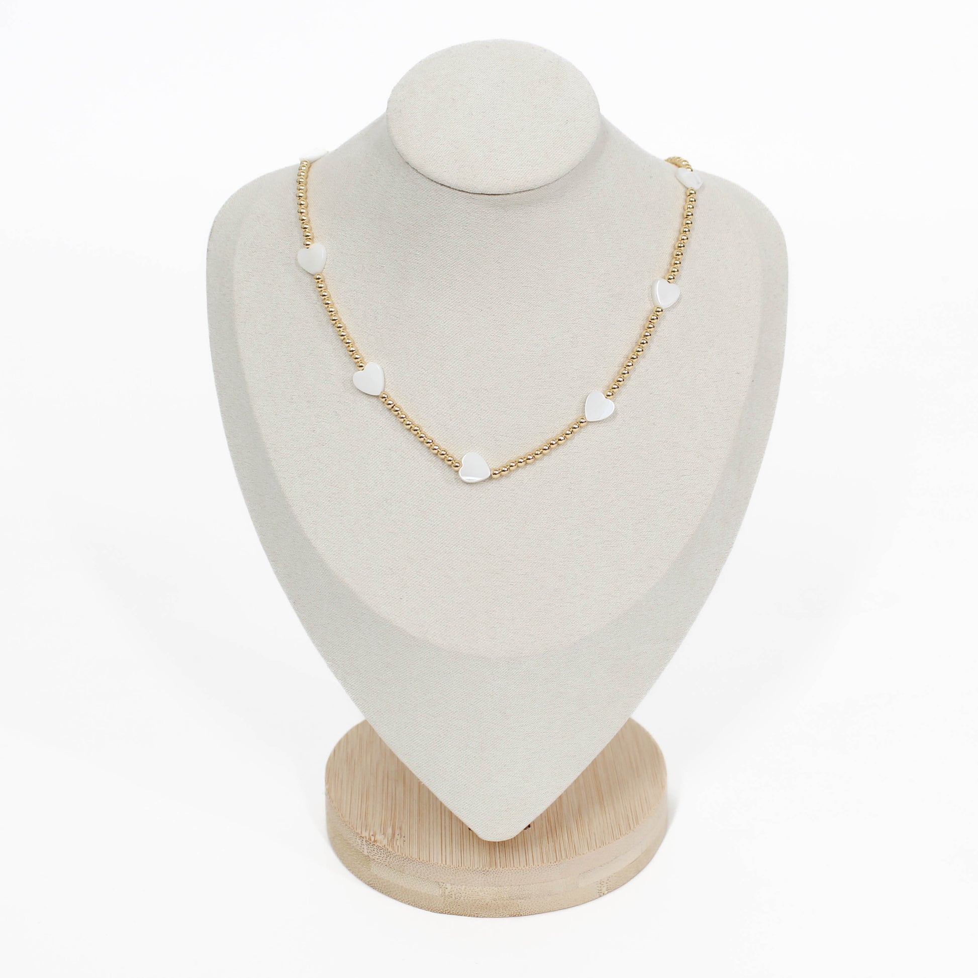 beaded pearl icon Necklace with heart-shaped pendants on a white mannequin bust