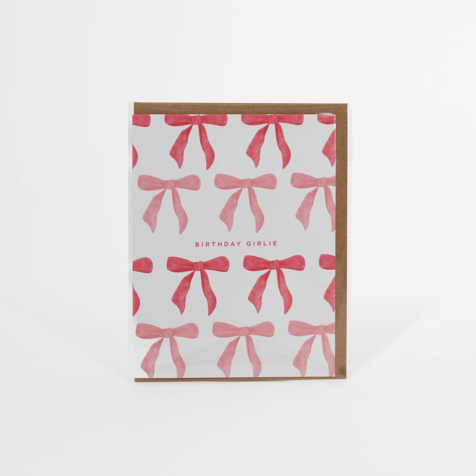 Card tat says 'Birthday Girlie' with different color pink bows surrounding it 