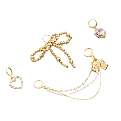 Set of gold bow shoe charms with various designs on a white background