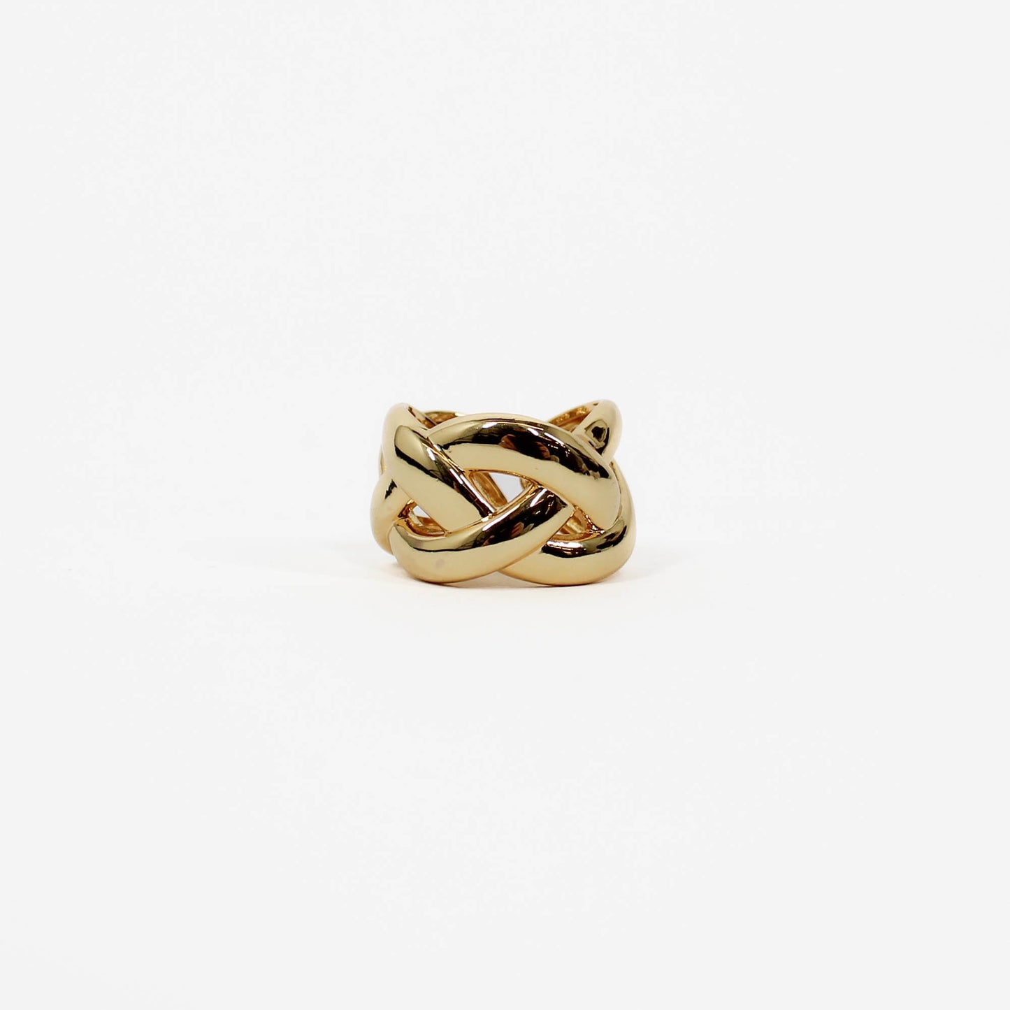 Gold braided band ring with a knot design on a white background