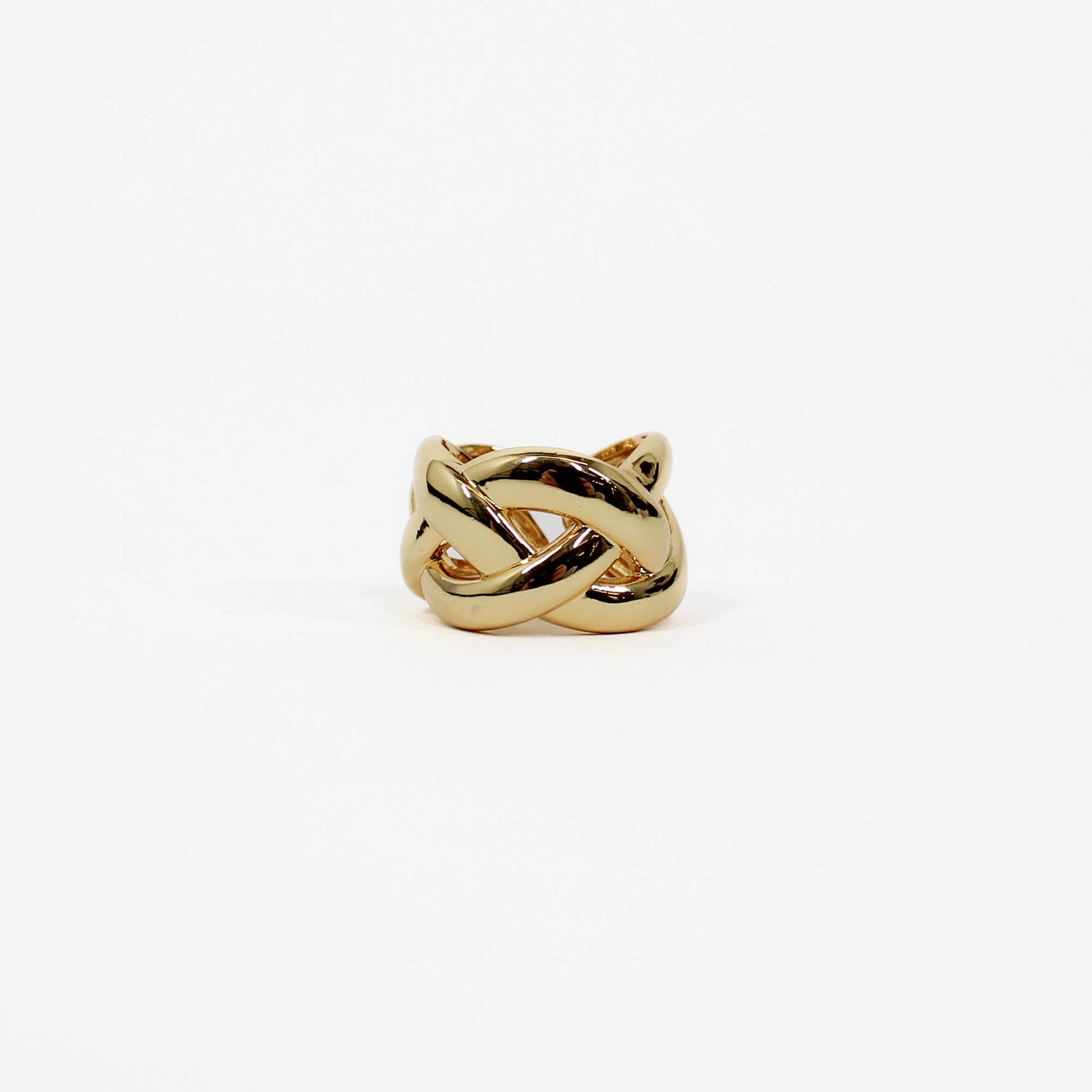 Gold braided band ring with a knot design on a white background