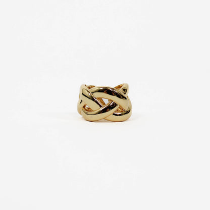 Gold braided band ring with a knot design on a white background