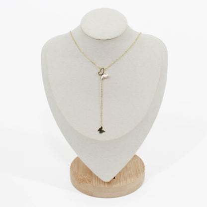 Gold butterfly lariat necklace on a mannequin on a white background 
