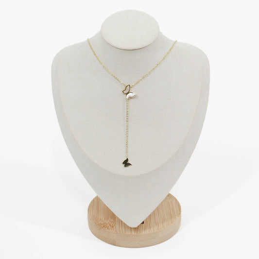 Gold butterfly lariat necklace on a mannequin on a white background 