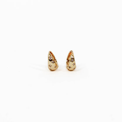 Gold teardrop-shaped celestial star dome earrings on a white background