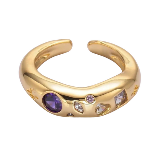 Gold ring with embedded celestial gemstones on a white background