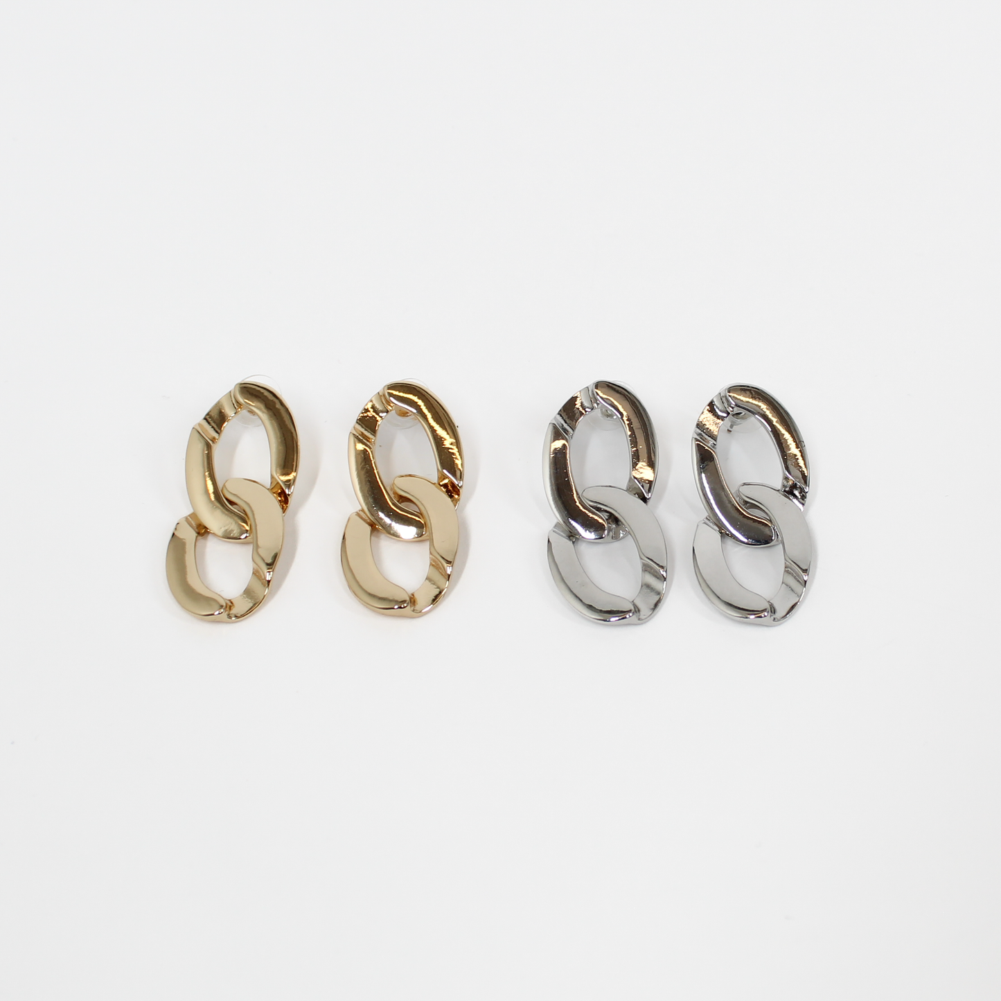 Pairs of gold and silver chain link drop earrings on a white background