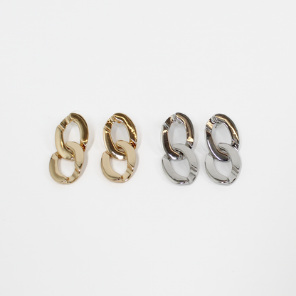 Pairs of gold and silver chain link drop earrings on a white background