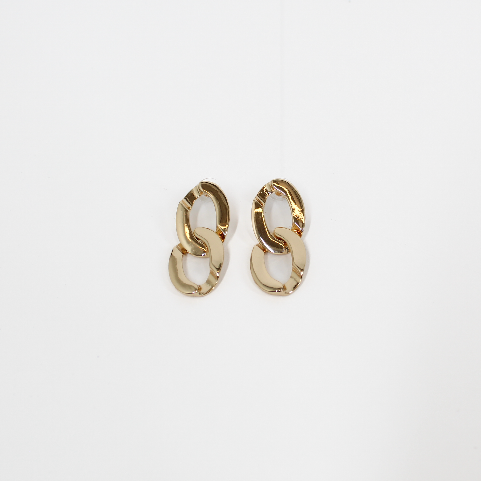 Gold chain-link drop earrings on a white background