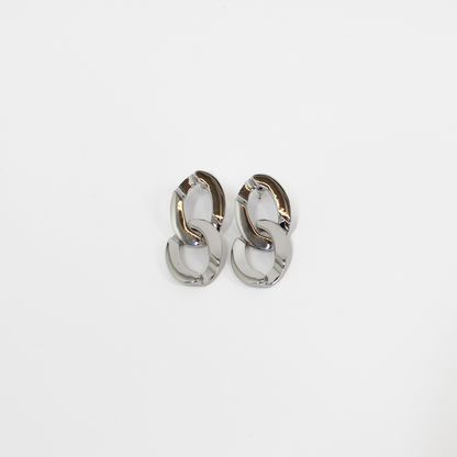 Pair of silver chain link drop earrings on a white background