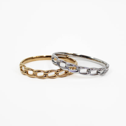 Two chain-link hinged bangle bracelets, one gold and one silver, on a white background