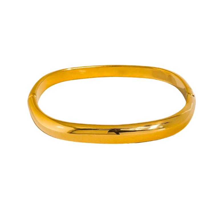 close up of gold bangle on white background